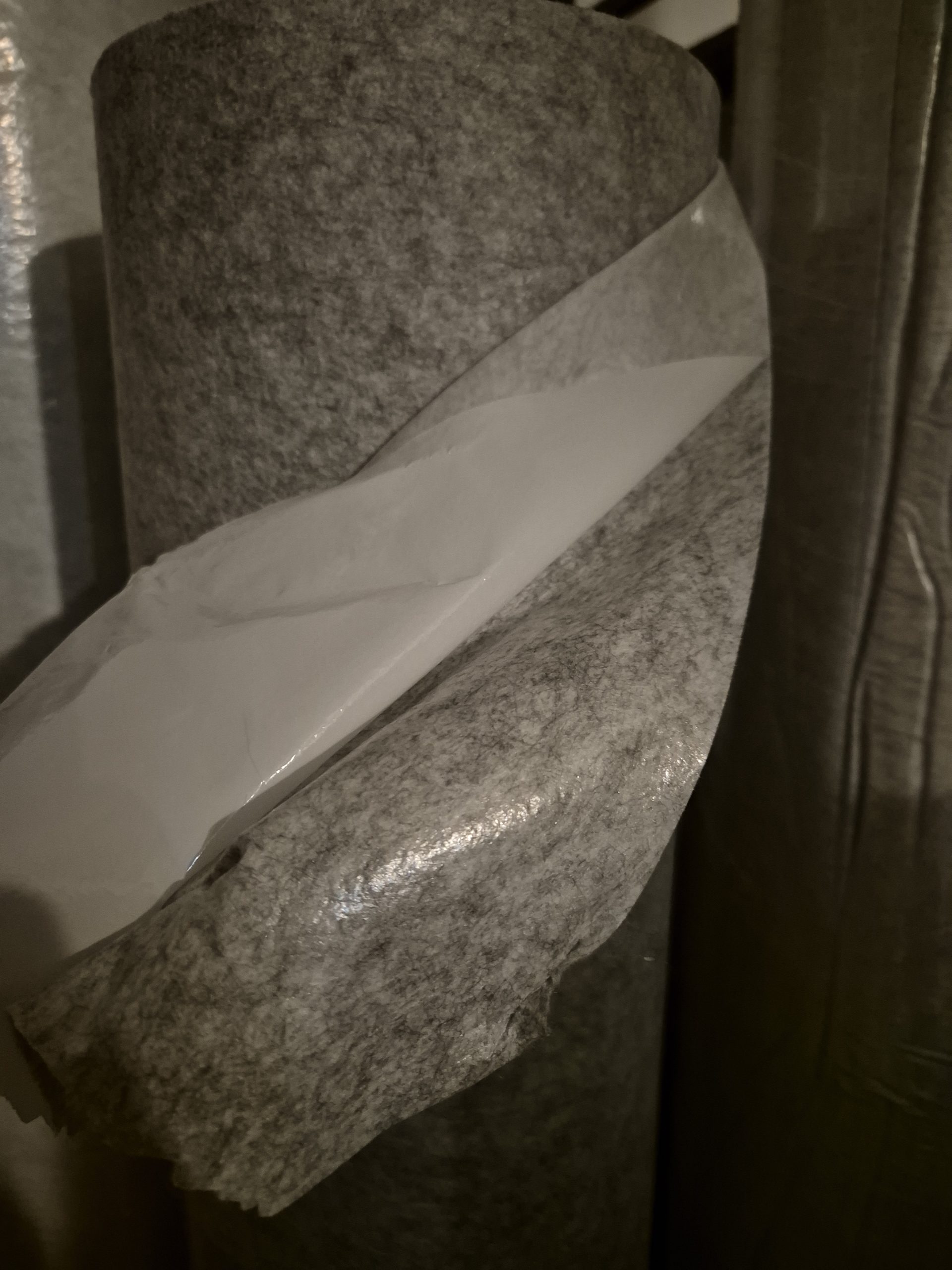 Self-adhesive nonwoven needlepunched felt